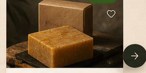 Stacked turmeric soap bars beside a kraft box with honey accents and leaves.